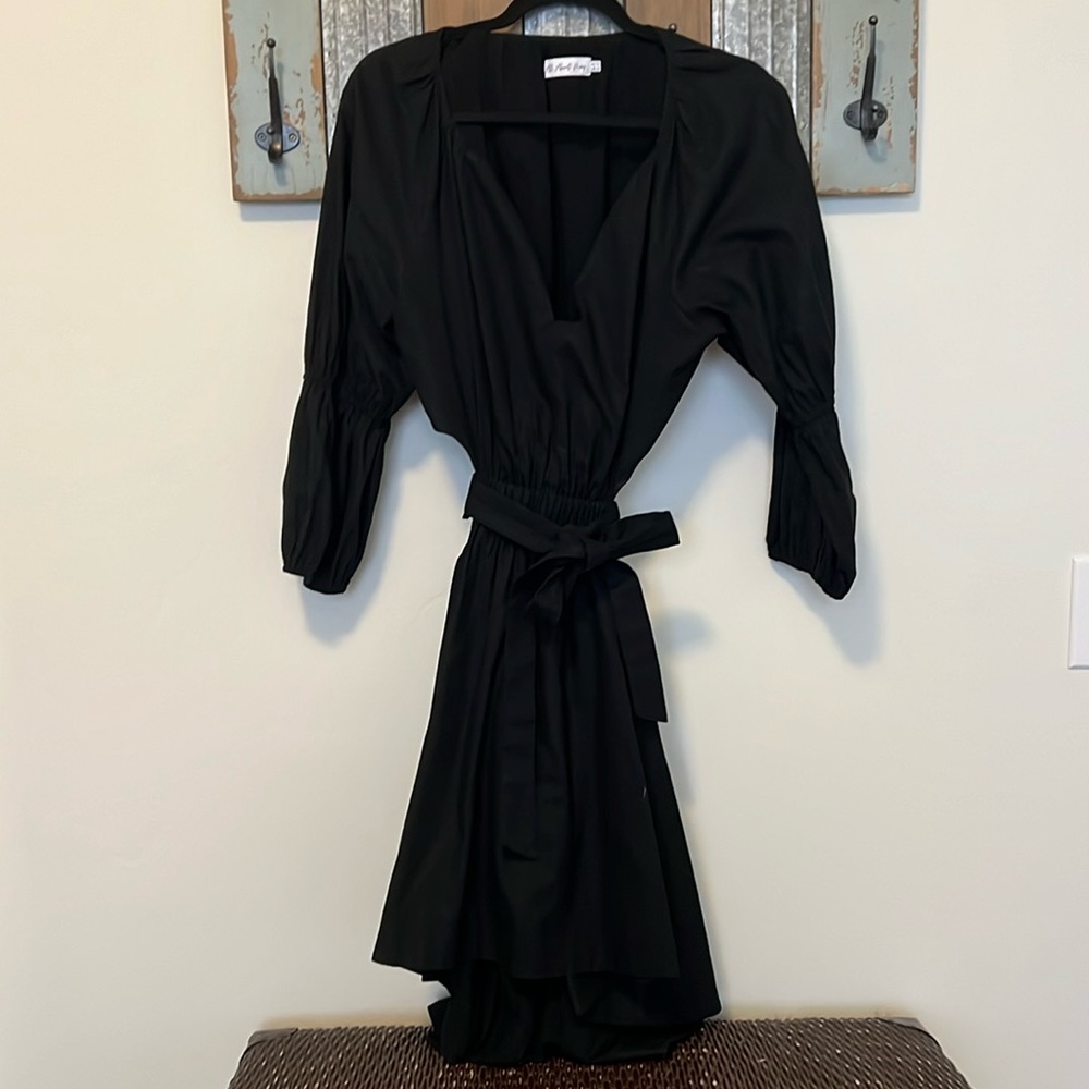 Black mini dress low back cut out with statement sleeves.